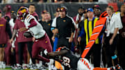Washington Commanders quarterback Jayden Daniels breaks away from a Cincinnati Bengals linebacker Akeem Davis-Gaither.