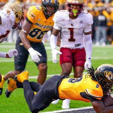 Sep 14, 2024; Columbia, Missouri, USA; Missouri Tigers running back Nate Noel (8) dives in for a two point conversion as Boston College Eagles linebacker Daveon Crouch (1) looks on during the first half at Faurot Field at Memorial Stadium. Mandatory Credit: Denny Medley-Imagn Images