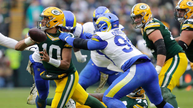 Packers quarterback Jordan Love throws an incomplete pass while under pressure from Rams defensive tackle Aaron Donald.