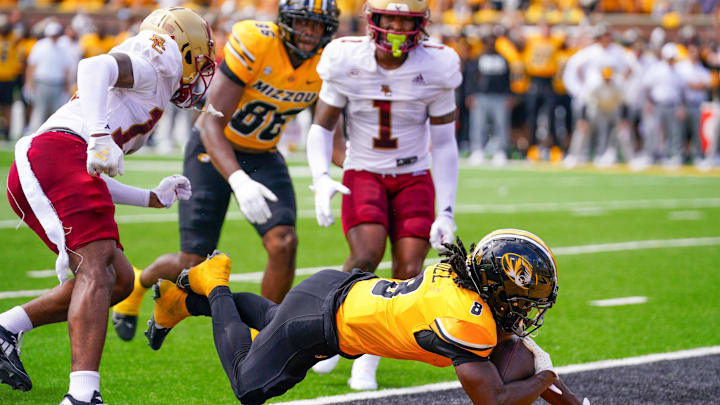 Sep 14, 2024; Columbia, Missouri, USA; Missouri Tigers running back Nate Noel (8) dives in for a two point conversion as Boston College Eagles linebacker Daveon Crouch (1) looks on during the first half at Faurot Field at Memorial Stadium. Mandatory Credit: Denny Medley-Imagn Images