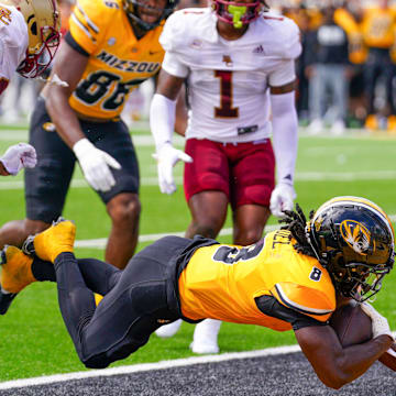 Sep 14, 2024; Columbia, Missouri, USA; Missouri Tigers running back Nate Noel (8) dives in for a two point conversion as Boston College Eagles linebacker Daveon Crouch (1) looks on during the first half at Faurot Field at Memorial Stadium. Mandatory Credit: Denny Medley-Imagn Images