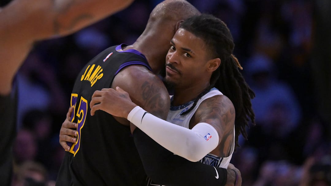 Jan 2, 2026; Los Angeles, California, USA; Los Angeles Lakers forward LeBron James (23) and Memphis Grizzlies guard Ja Morant (12) embrace following the game at Crypto.com Arena. Mandatory Credit: Jayne Kamin-Oncea-Imagn Images