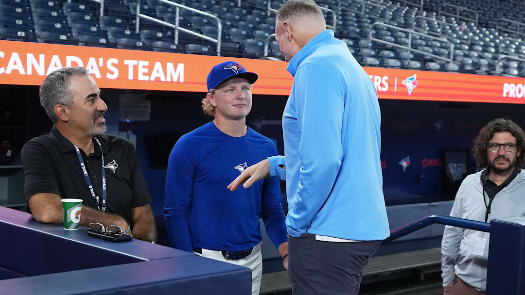 Sep 13, 2025; Toronto, Ontario, CAN; Toronto Blue Jays first round draft pick JoJo Parker talks to president and CEO Mark Shapiro during batting practice before a game against the Baltimore Orioles at Rogers Centre. Mandatory Credit: Nick Turchiaro-Imagn Images