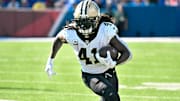 Sep 28, 2025; Orchard Park, New York, USA; New Orleans Saints running back Alvin Kamara (41) carries the ball against the Buffalo Bills in the third quarter at Highmark Stadium. Mandatory Credit: Mark Konezny-Imagn Images
