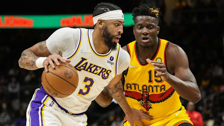 Jan 30, 2022; Atlanta, Georgia, USA; Los Angeles Lakers forward Anthony Davis (3) controls the ball against Atlanta Hawks center Clint Capela (15) during the first half at State Farm Arena. Mandatory Credit: Dale Zanine-Imagn Images