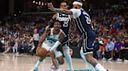 Apr 18, 2025; Memphis, Tennessee, USA; Memphis Grizzlies guard Ja Morant (12) drives to the basket against Dallas Mavericks center Daniel Gafford (21) during the third quarter at FedExForum. Mandatory Credit: Petre Thomas-Imagn Images
