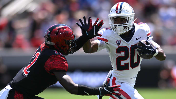 Sep 3, 2022; San Diego, California, USA; Arizona Wildcats running back Rayshon Luke (20) runs the ball while defended by San Diego State Aztecs cornerback Dallas Branch (12) during the first half at Snapdragon Stadium