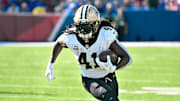 Sep 28, 2025; Orchard Park, New York, USA; New Orleans Saints running back Alvin Kamara (41) carries the ball against the Buffalo Bills in the third quarter at Highmark Stadium. Mandatory Credit: Mark Konezny-Imagn Images