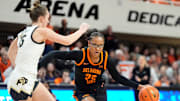 Oklahoma State guard Stailee Heard (32) drives to the basket as Colorado guard Kindyll Wetta (15) defends during the college basketball game between the Oklahoma State University Cowgirls and the Colorado Buffaloes, Saturday, Feb., 22, 2025.