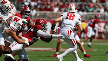 Sep 13, 2025; Tuscaloosa, Alabama, USA; Wisconsin Badgers quarterback Danny O'Neil (18) is pursued by Alabama Crimson Tide defensive lineman LT Overton (22) during the first quarter at Saban Field at Bryant-Denny Stadium. Mandatory Credit: David Leong-Imagn Images