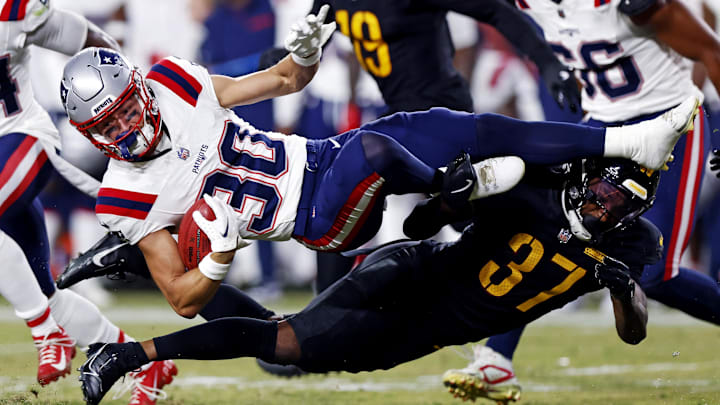 Former Patriots kick returner/receiver David Wallis is tackles during the preseason by David Whiteside.