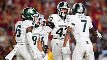 Sep 20, 2025; Los Angeles, California, USA; Michigan State Spartans defensive back Malik Spencer (43) celebrates a defensive play against the Southern California Trojans with defensive back Joshua Eaton (7) during the first half at the Los Angeles Memorial Coliseum. Mandatory Credit: Gary A. Vasquez-Imagn Images