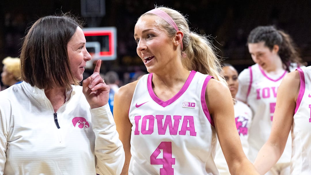 Iowa Assistant Coach Abby Stamp talks to Iowa guard Kylie Feuerbach (4) as they walk off the court after a game against the Washington Huskies Feb. 11, 2026 at Carver-Hawkeye Arena in Iowa City, Iowa.