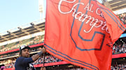 Sep 28, 2025; Cleveland, Ohio, USA;  Cleveland Guardians third baseman Jose Ramirez (11) plants the flag after the Guardians beat the Texas Rangers and won the American League Central Division at Progressive Field. Mandatory Credit: Ken Blaze-Imagn Images