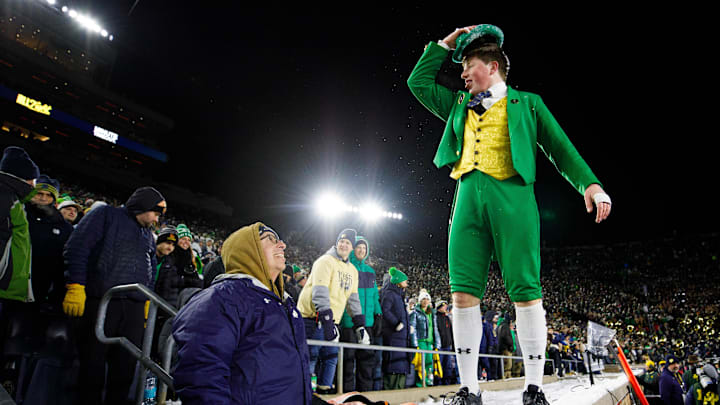 The Notre Dame Leprechaun walks on the ledge in front of fans during the first round of the College Football Playoff 