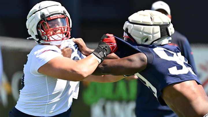 Jul 23, 2025; Foxborough, MA, USA; New England Patriots offensive tackle Will Campbell (66) and defensive end Keion White (99) work on a drill during training camp at Gillette Stadium. Mandatory Credit: Eric Canha-Imagn Images
