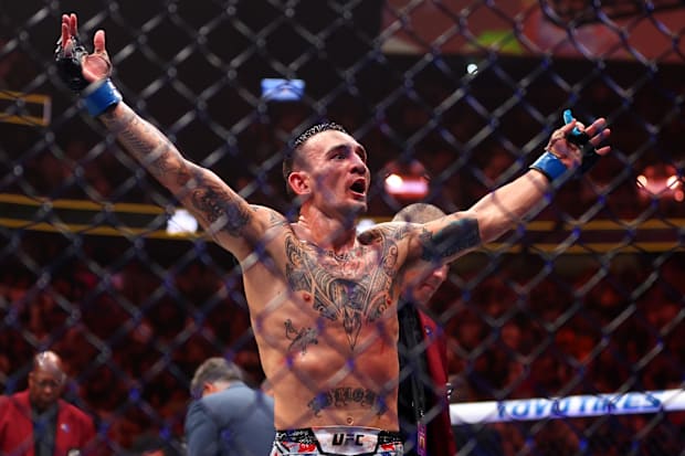 Max Holloway (blue gloves) reacts after defeating Justin Gaethje (not pictured) during UFC 300 at T-Mobile Arena. 