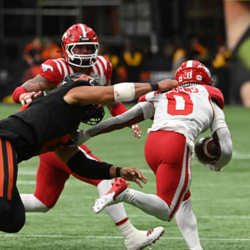 Jun 15, 2024; Vancouver, British Columbia, CAN;  BC Lions defensive lineman Sione Teuhema (0) tackles Calgary Stampeders defensive back Kobe Williams (0) during the second half at BC Place. Mandatory Credit: Simon Fearn-USA TODAY Sports