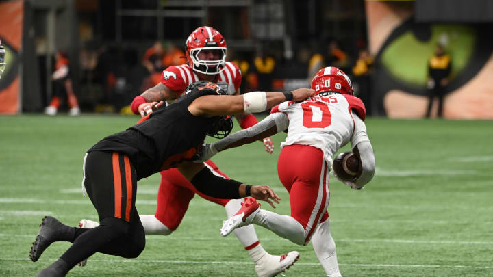 Jun 15, 2024; Vancouver, British Columbia, CAN;  BC Lions defensive lineman Sione Teuhema (0) tackles Calgary Stampeders defensive back Kobe Williams (0) during the second half at BC Place. Mandatory Credit: Simon Fearn-USA TODAY Sports