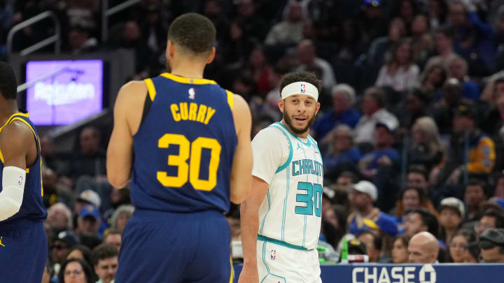 Feb 23, 2024; San Francisco, California, USA; Charlotte Hornets guard Seth Curry (right) talks with Golden State Warriors guard Stephen Curry (left) during the fourth quarter at Chase Center. Mandatory Credit: Darren Yamashita-USA TODAY Sports