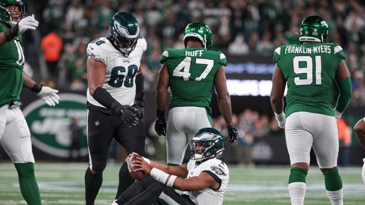 Oct 15, 2023; East Rutherford, New Jersey, USA; Philadelphia Eagles quarterback Jalen Hurts (1) reacts after being sacked by New York Jets linebacker Bryce Huff (47) during the second half at MetLife Stadium. 