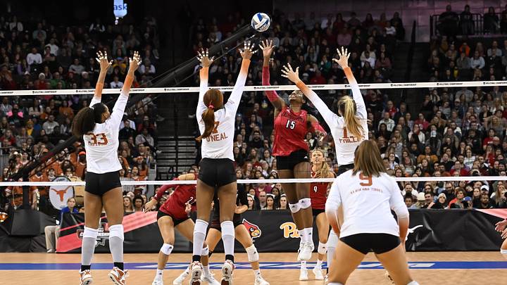 Dec 17, 2022; Omaha, Nebraska, US;  Louisville Cardinals Aiko Jones (15) attacks the block from the Texas Longhorns at CHI Health Center. Mandatory Credit: Steven Branscombe-USA TODAY Sports
