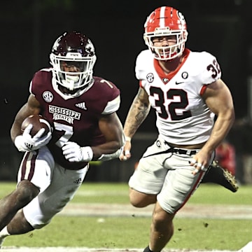 Nov 12, 2022; Starkville, Mississippi, USA;Mississippi State Bulldogs running back Jo'quavious Marks (7) runs the ball against Georgia Bulldogs linebacker Chaz Chambliss (32) during the fourth quarter at Davis Wade Stadium at Scott Field. Mandatory Credit: Matt Bush-Imagn Images