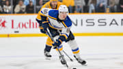 Mar 27, 2025; Nashville, Tennessee, USA;  St. Louis Blues center Dylan Holloway (81) skates with the puck against the Nashville Predators during the second period at Bridgestone Arena. Mandatory Credit: Steve Roberts-Imagn Images