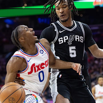 Dec 23, 2024; Philadelphia, Pennsylvania, USA; Philadelphia 76ers guard Tyrese Maxey (0) drives against San Antonio Spurs guard Stephon Castle (5) during the second quarter at Wells Fargo Center. Mandatory Credit: Bill Streicher-Imagn Images
