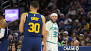 Feb 23, 2024; San Francisco, California, USA; Charlotte Hornets guard Seth Curry (right) talks with Golden State Warriors guard Stephen Curry (left) during the fourth quarter at Chase Center. Mandatory Credit: Darren Yamashita-Imagn Images