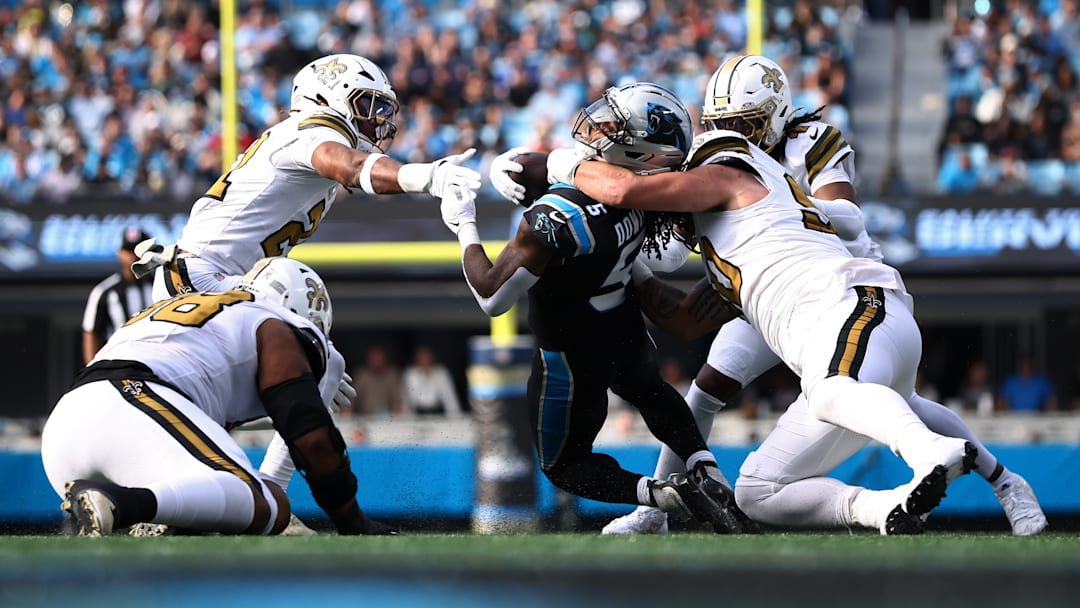 New Orleans Saints defenders bring down Carolina Panthers running back Rico Dowdle (5) on Nov. 10, 2025.