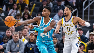 Oct 17, 2024; Indianapolis, Indiana, USA; Charlotte Hornets forward Brandon Miller (24) passes the ball while  Indiana Pacers guard Tyrese Haliburton (0) defends in the first half at Gainbridge Fieldhouse. Mandatory Credit: Trevor Ruszkowski-Imagn Images