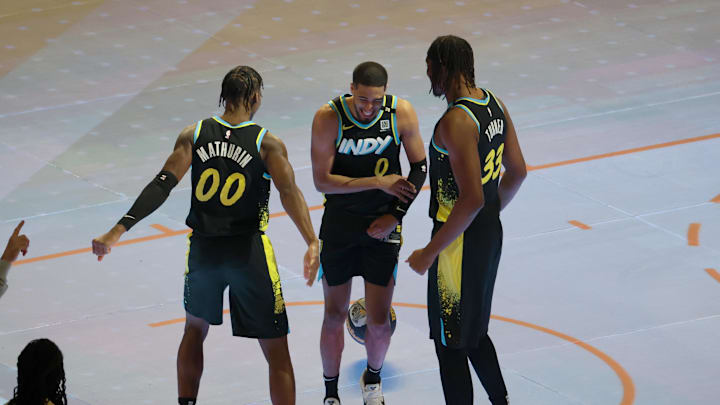 Feb 17, 2024; Indianapolis, IN, USA; Indiana Pacers guard Tyrese Haliburton (0) celebrates with guard Bennedict Mathurin (00) and center Myles Turner (33) during the Kia Skills Challenge during NBA All Star Saturday Night at Lucas Oil Stadium. Mandatory Credit: Trevor Ruszkowski-Imagn Images