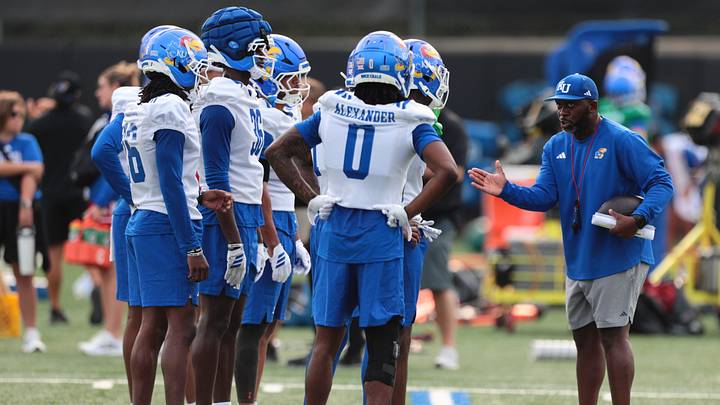 Kansas defensive backs coach Brandon Shelby talks with players during fall camp practice on Aug. 4, 2026.