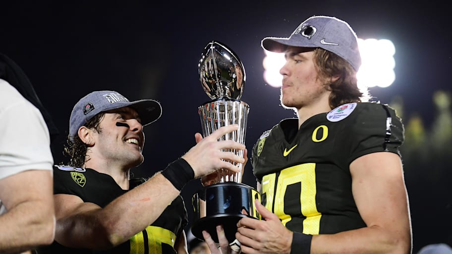 Oregon Ducks safety Brady Breeze and quarterback Justin Herbert celebrate winning the Rose Bowl vs. Wisconsin.