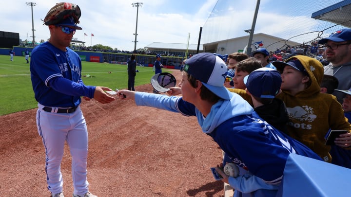 Mar 15, 2023; Dunedin, Florida, USA;  Toronto Blue Jays right fielder Daulton Varsho (25) signs