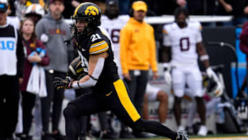 Iowa Hawkeyes wide receiver Kaden Wetjen (21) runs a punt return back scoring a touchdown against the Minnesota Golden Gophers Oct. 25, 2025 at Kinnick Stadium in Iowa City, Iowa.