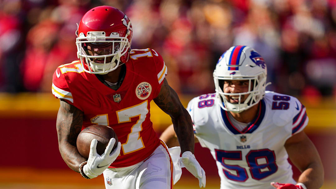 Kansas City Chiefs wide receiver Mecole Hardman (17) runs with the ball past Buffalo Bills linebacker Matt Milano (58) during the first half at GEHA Field at Arrowhead Stadium.