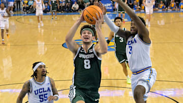 Feb 4, 2025; Los Angeles, California, USA; Michigan State Spartans forward Frankie Fidler (8) drives past UCLA Bruins guard Skyy Clark (55) and guard Eric Dailey Jr. (3) in the second half at Pauley Pavilion presented by Wescom. Mandatory Credit: Jayne Kamin-Oncea-Imagn Images