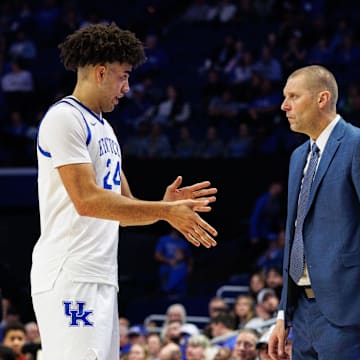 Nov 4, 2025; Lexington, Kentucky, USA; Kentucky Wildcats center Malachi Moreno (24) talks with head coach Mark Pope during the second half against the Nicholls Colonels at Rupp Arena at Central Bank Center. Mandatory Credit: Jordan Prather-Imagn Images