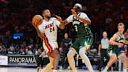 Oct 6, 2025; Miami, Florida, USA; Miami Heat guard Norman Powell (24) drives to the basket against Milwaukee Bucks center Myles Turner (3) during the second quarter at Kaseya Center. Mandatory Credit: Sam Navarro-Imagn Images