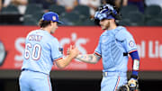 Jul 27, 2025; Arlington, Texas, USA; Texas Rangers pitcher Cole Winn (60) and catcher Jonah Heim (28) celebrate after the ninth inning against the Atlanta Braves at Globe Life Field. 