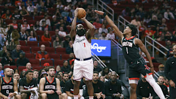 Nov 15, 2024; Houston, Texas, USA; Los Angeles Clippers guard James Harden (1) makes a three-point basket during the second quarter as Houston Rockets forward Amen Thompson (1) defends at Toyota Center. Mandatory Credit: Troy Taormina-Imagn Images