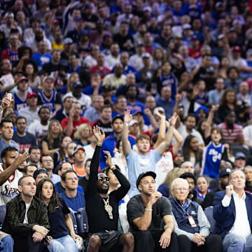 May 2, 2024; Philadelphia, Pennsylvania, USA; Philadelphia 76ers forward Nicolas Batum (40) shoots as musical artist Meek Mill (on left with sunglasses and neck jewelry) mimics his shooting action during the second half of game six of the first round for the 2024 NBA against the New York Knicks playoffs at Wells Fargo Center. Mandatory Credit: Bill Streicher-Imagn Images