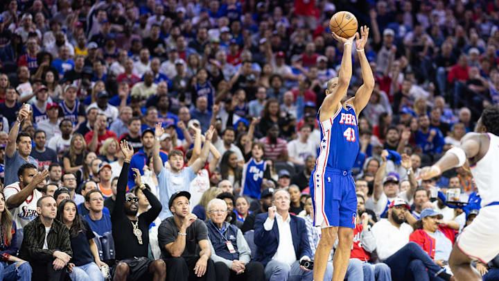 May 2, 2024; Philadelphia, Pennsylvania, USA; Philadelphia 76ers forward Nicolas Batum (40) shoots as musical artist Meek Mill (on left with sunglasses and neck jewelry) mimics his shooting action during the second half of game six of the first round for the 2024 NBA against the New York Knicks playoffs at Wells Fargo Center. Mandatory Credit: Bill Streicher-Imagn Images