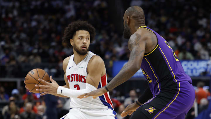 Nov 4, 2024; Detroit, Michigan, USA;  Detroit Pistons guard Cade Cunningham (2) is defended by Los Angeles Lakers forward LeBron James (23): Rick Osentoski-Imagn Images
