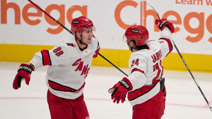 Oct 17, 2023; San Jose, California, USA; Carolina Hurricanes center Seth Jarvis (24) celebrates with center Martin Necas (88) after scoring a goal against the San Jose Sharks during the third period at SAP Center at San Jose. Mandatory Credit: Robert Edwards-USA TODAY Sports