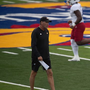 Kansas head coach Lance Leipold walks down the 40-yard line as his players hold their first practice inside David Booth Kansas Memorial Stadium on Aug. 1, 2025.