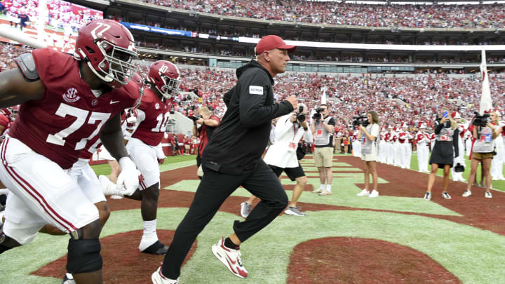 Aug 31, 2024; Tuscaloosa, Alabama, USA;  Alabama Crimson Tide head coach Kalen DeBoer leads his players onto the field at Bryant-Denny Stadium for his first game as head coach. The Crimson Tide played  Western Kentucky Hilltoppers. Mandatory Credit: Gary Cosby Jr.-USA TODAY Sports