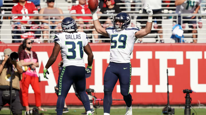 Oct 3, 2021; Santa Clara, California, USA; Seattle Seahawks linebacker Jon Rhattigan (59) celebrates with running back DeeJay Dallas (31) after recovering a fumble during the third quarter against the San Francisco 49ers at Levi's Stadium.